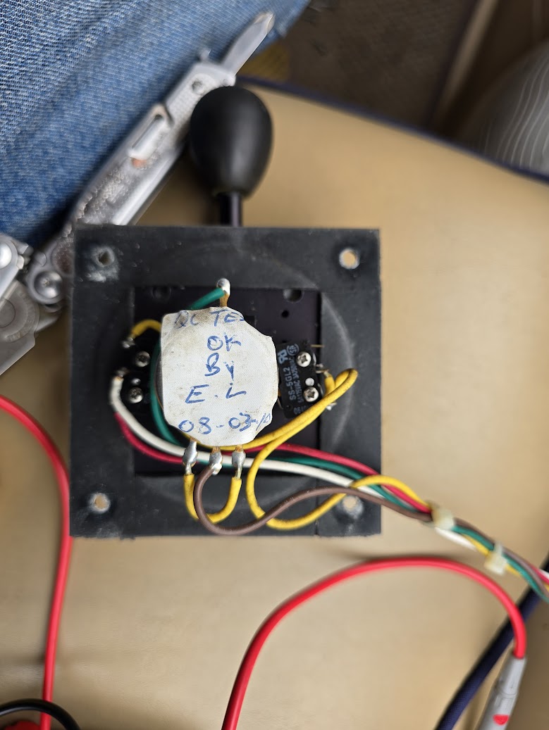 Rear of a vintage wig-wag throttle showing its switches and wiring