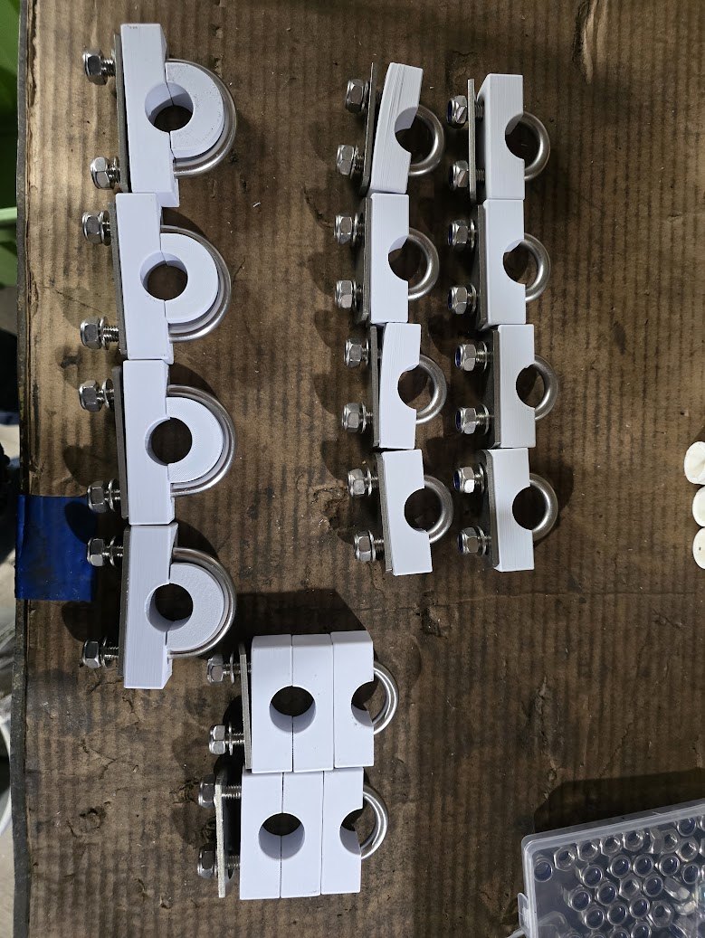 Batch of white 3D-printed split clamps fitted with stainless U-bolts